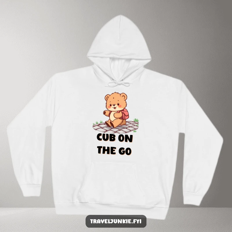 Funny hoodie featuring a fluffy bear cub with a backpack joyfully skipping on cobblestones, perfect for cozy and humorous wear.