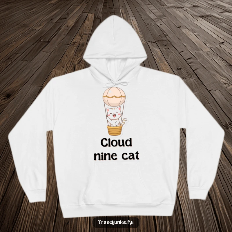 Funny cat hoodie featuring a joyful character blissfully riding in a miniature hot air balloon, offering humorous comfort and wanderlust.