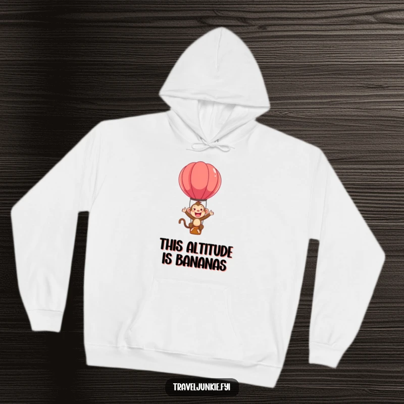 Funny hoodie featuring a hyperactive monkey character having a blast bouncing on a hot air balloon, full of excitement.